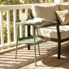 The light green two-tier round coffee end table on a wooden deck