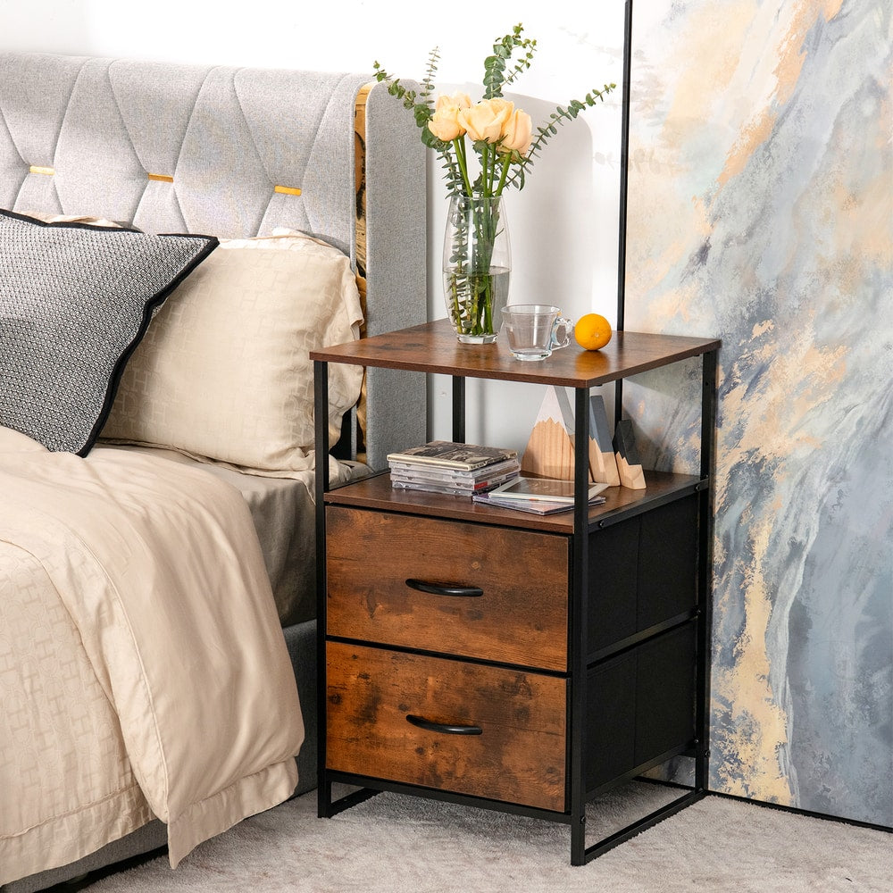 Rustic brown metal frame storage cabinet with two drawers next to a bed