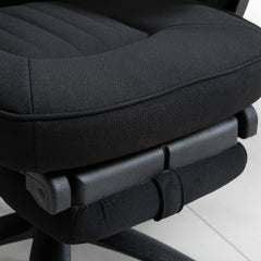 A close-up of the padded seat cushion and the retracted footrest underneath