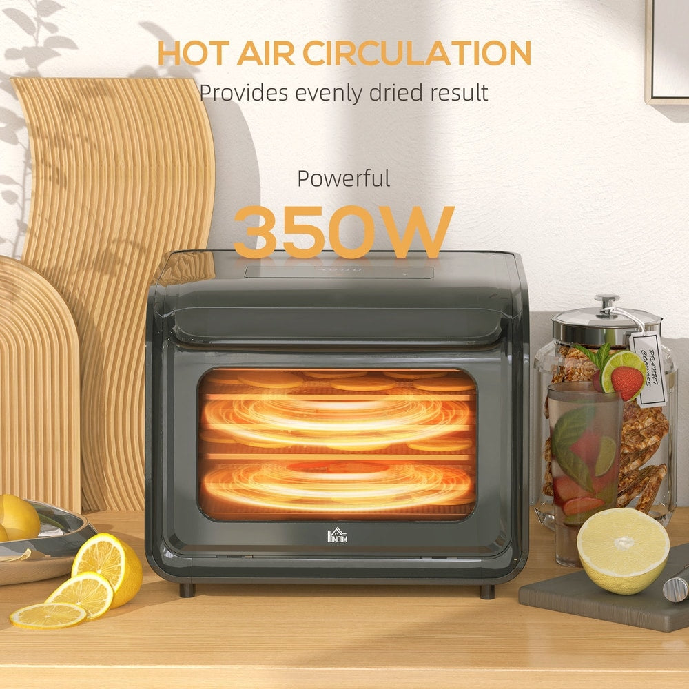 Black six-tray food dehydrator with the interior illuminated, showing hot air circulation