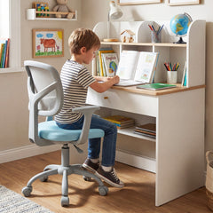 A boy sits at a desk using this blue kids desk chair