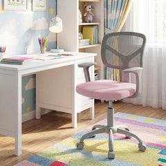 The pink kids desk chair sits in a child's bedroom with colourful decor
