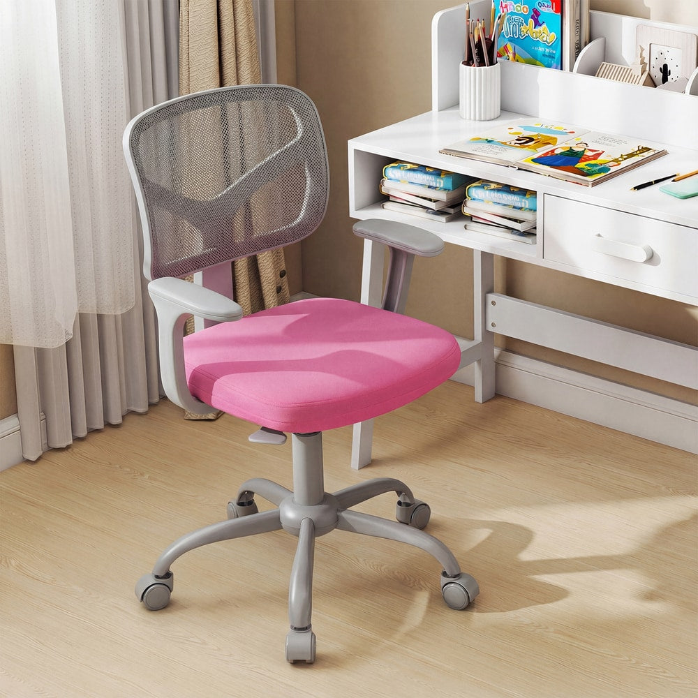 The pink kids desk chair sits in front of a white desk with books