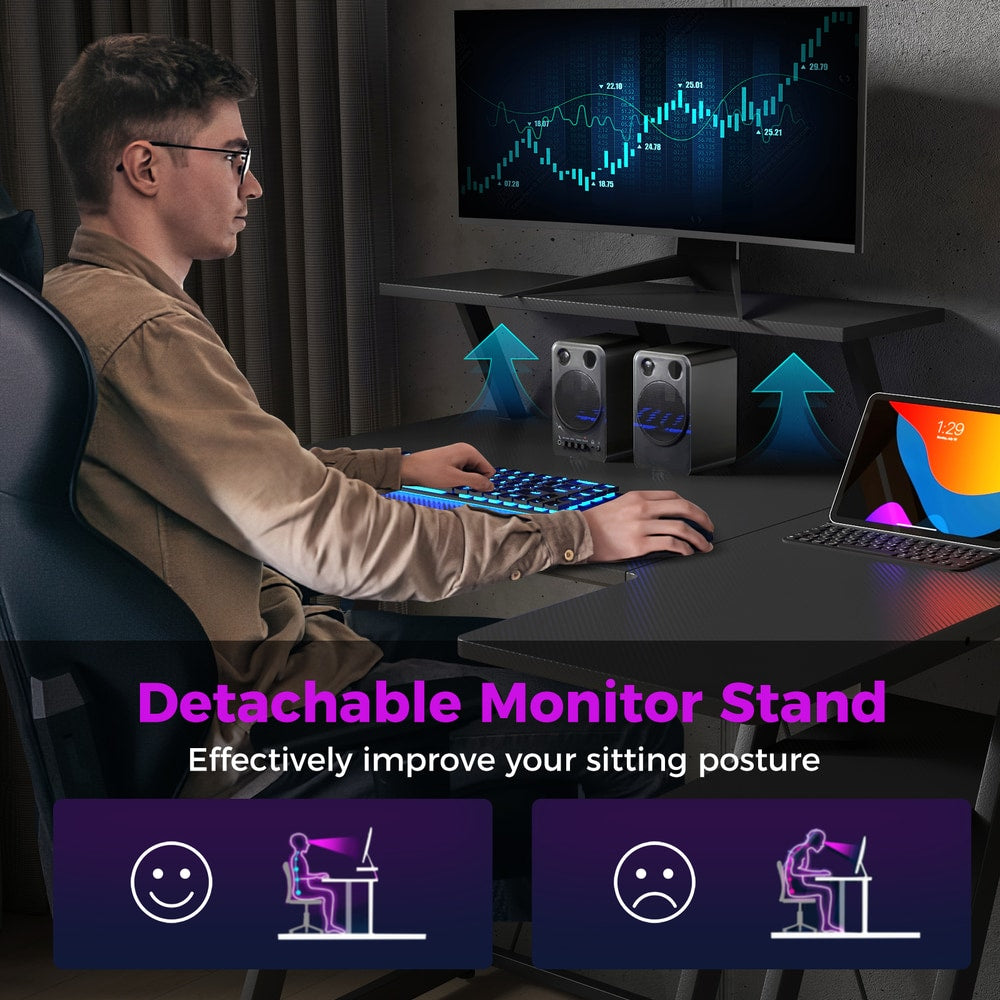 The office desk with a person sitting at it showing the benefit of the monitor shelf
