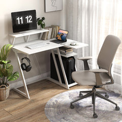 The L-shaped gaming desk in a home office setting with a chair and plant