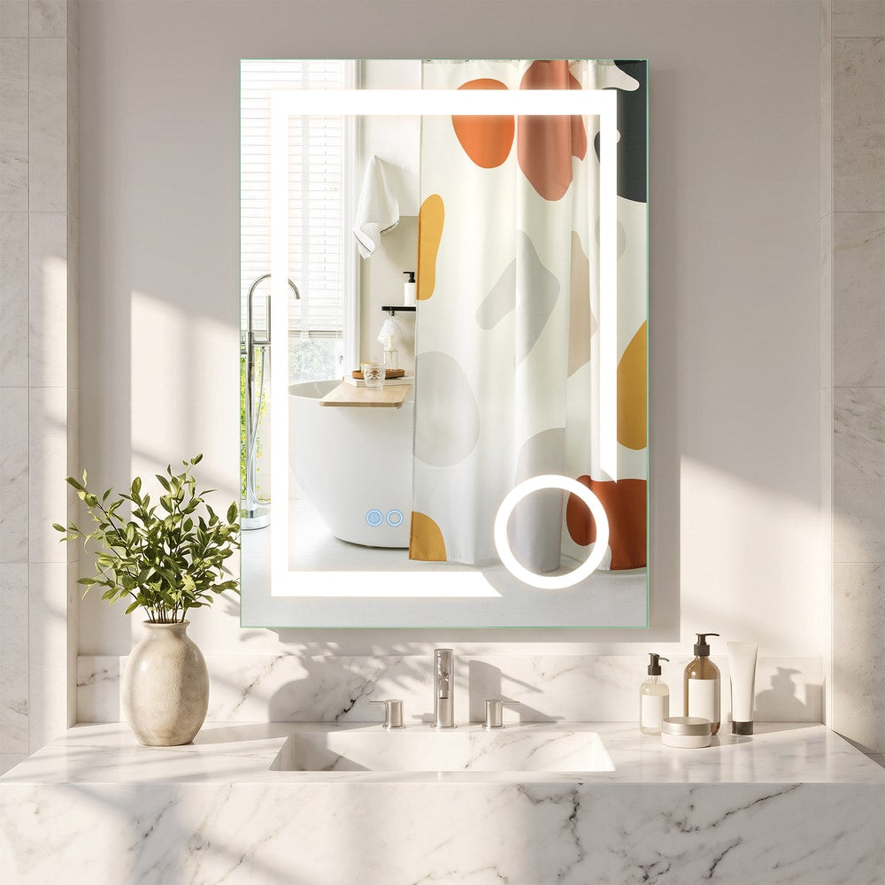 The bathroom mirror hanging above a marble vanity unit with a patterned shower curtain