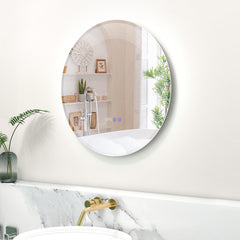 The glowing circular mirror fixed to a white wall above a marble vanity with gold tap