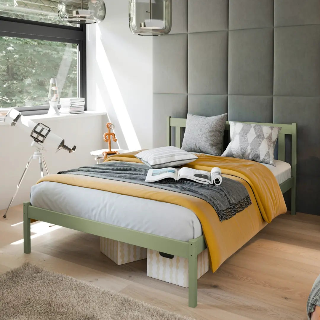 The wooden bed frame in a green colour, set up in a child's bedroom