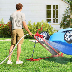 The garden tool holding a mower at an angle while a man cleans the underside with a water hose