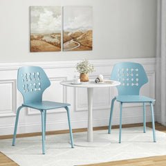 Two blue metal dining chairs next to a small white table in a room