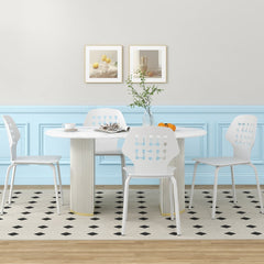 Four white metal dining chairs arranged around a modern dining table