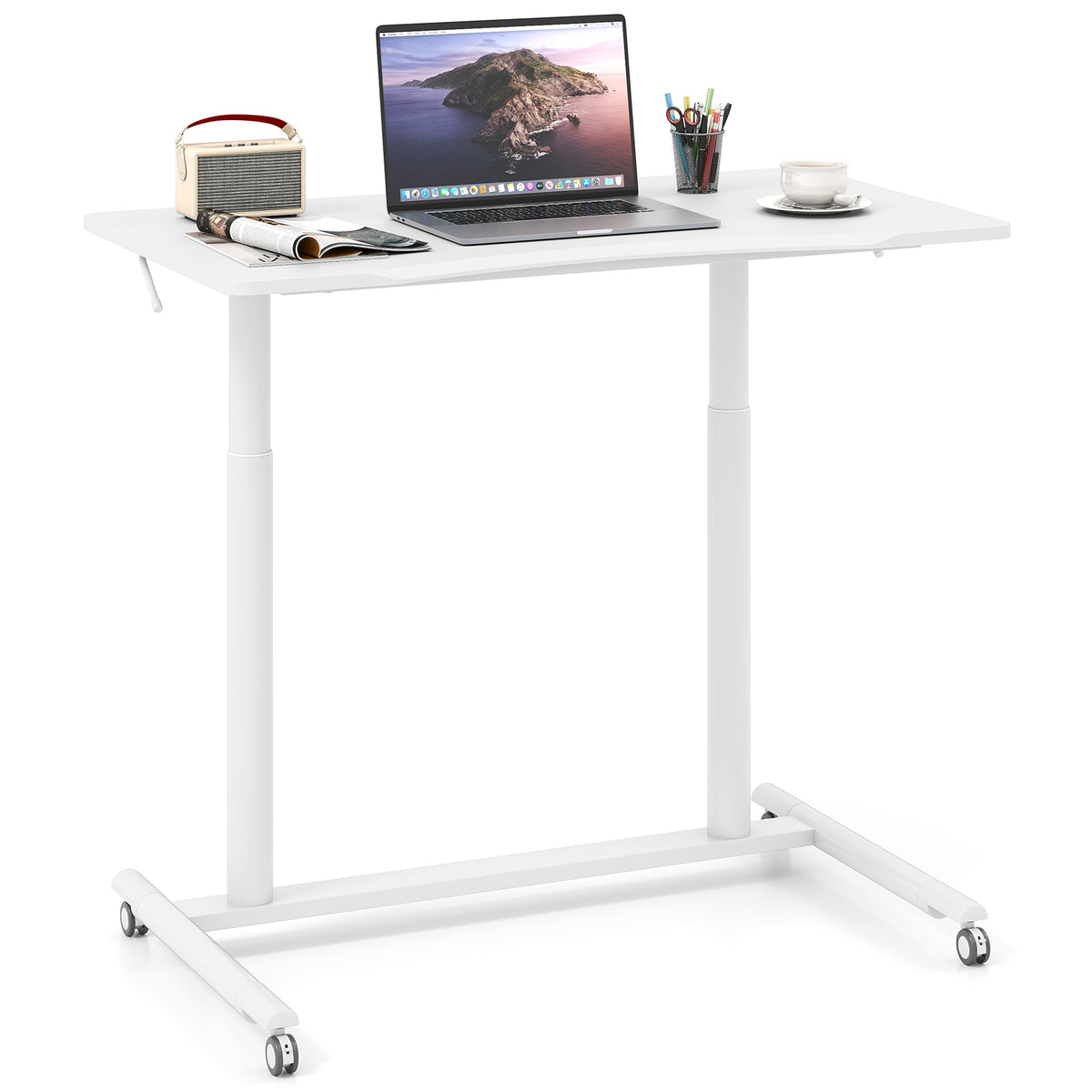 A white mobile standing desk with a laptop, speaker, and coffee cup on top