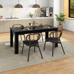 Black rectangular dining table with chairs in a breakfast nook setting