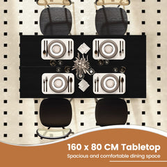 Overhead view of the black dining table set for four people