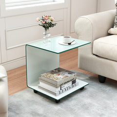 The side table placed next to a sofa in a living room with books and a vase of flowers on top