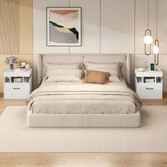 Two white bedside tables with drawers and charging stations flanking a bed