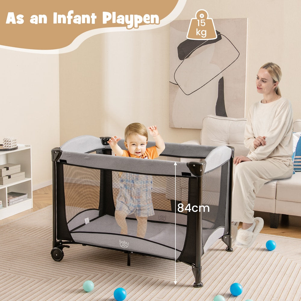 The portable nursery center set up as a playpen with a baby inside and a woman sitting nearby