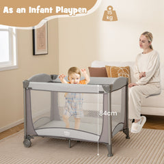Baby playing in the grey nursery center as a playpen