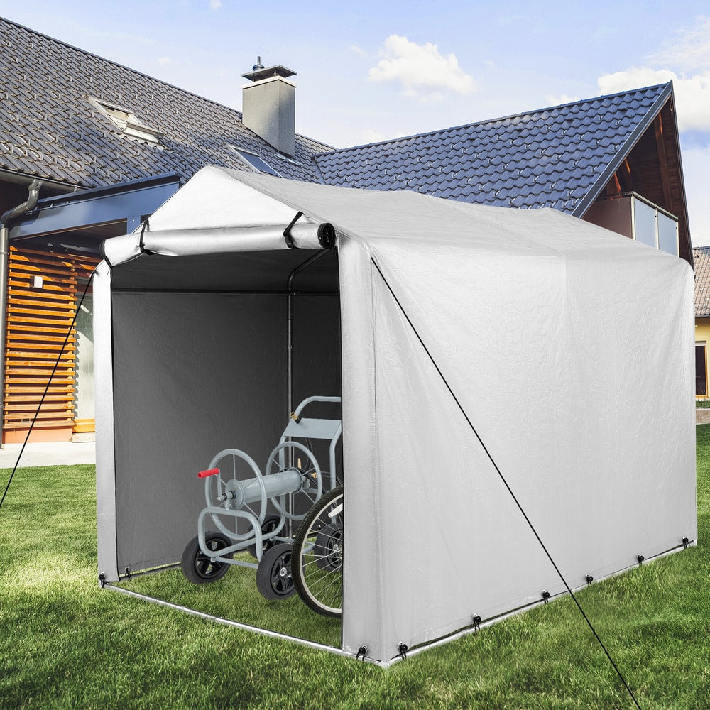 The portable garage shelter for bikes with a hose reel and bicycle stored inside on grass