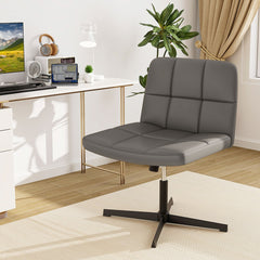 Grey office chair with no wheels positioned at a desk with a computer and headphones