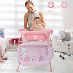 Mother bathing her baby in the pink baby change table bathtub