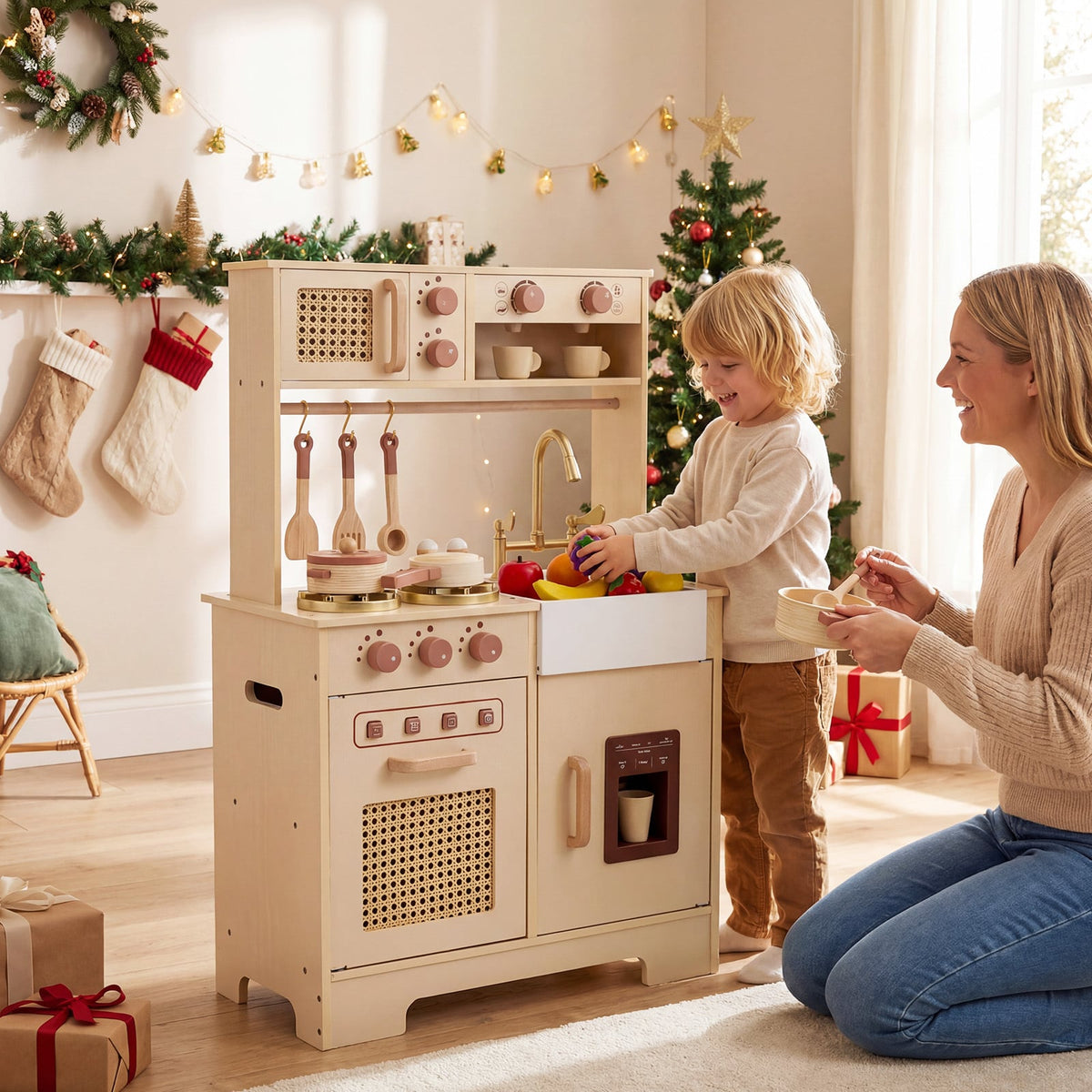 The wooden kitchen set being used by a child and adult in a festive Christmas setting