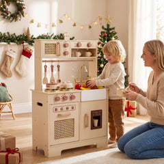 The wooden kitchen set being used by a child and adult in a festive Christmas setting