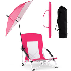 A pink beach chair with parasol, a folded parasol and a black carry bag