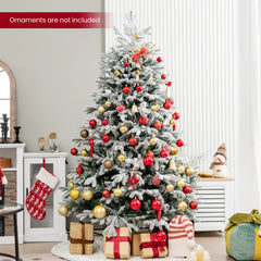 The decorated christmas tree standing in a living room with presents underneath
