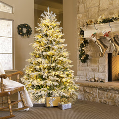 The christmas tree placed in a cosy corner next to a fireplace and a rocking chair