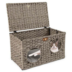 Close up of the rattan cat house with a cat peeking out of the entrance hole