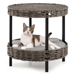A cat resting on the lower level of the rattan pet furniture set
