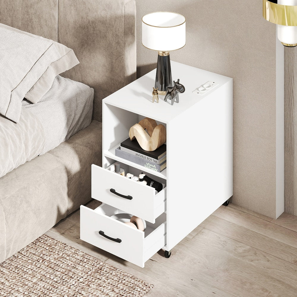 The nightstand with two drawers and a shelf, next to a bed with a lamp