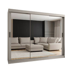 A light grey sliding door wardrobe with mirrored doors standing in a bright room