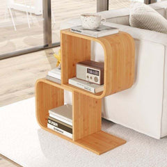 The bookcase placed next to a white sofa with books and a radio stored on the shelves