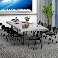The office chairs placed around a large grey conference table in a modern meeting room