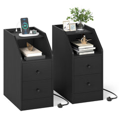 The black side tables styled with books, a plant and charging devices on the top shelf