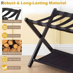 Close up of the black folding luggage rack showing nylon straps and rubberwood frame