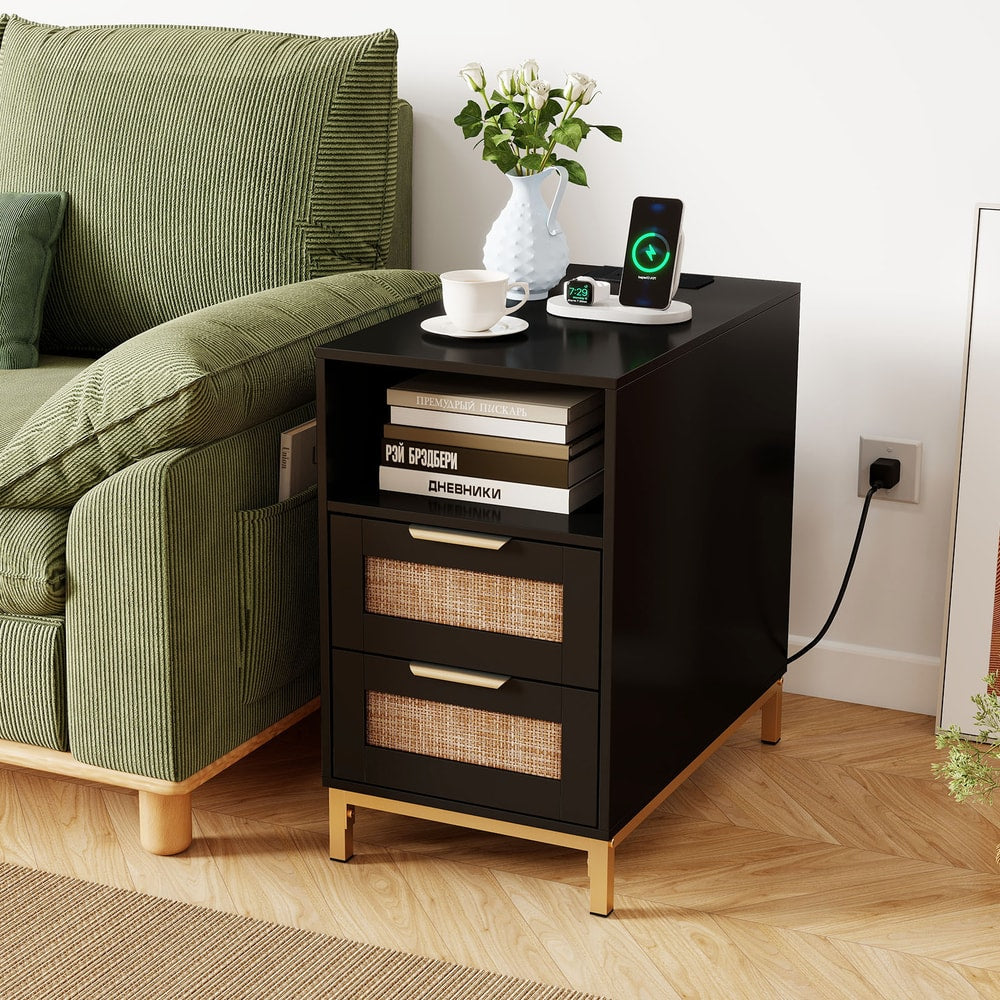 Black narrow end table with rattan drawers next to a sofa