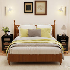 Black narrow end table with rattan drawers in a bedroom setting