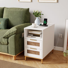 A white narrow end table next to a green sofa in a living room