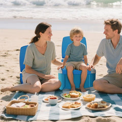 Family enjoying a picnic on the beach with the blue chairs