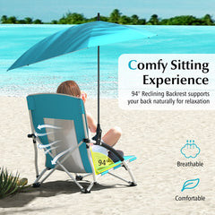 A person sitting comfortably in a breathable beach chair with an adjustable parasol