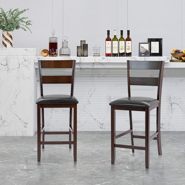 Two upholstered bar stools in a kitchen setting with a marble countertop