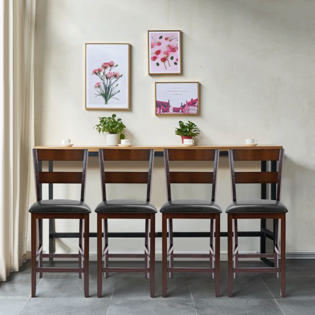 Four upholstered bar stools lined up against a wall with artwork above