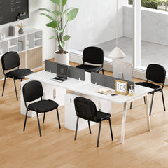 The office chairs placed around a white desk in a modern bright workspace with wooden flooring
