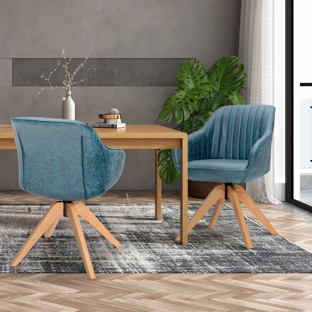 Two blue accent chairs at a wooden dining table