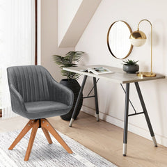A grey fabric dining chair with wooden legs next to a desk