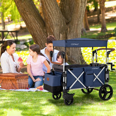 The blue double stroller wagon being used by a family having a picnic in a park