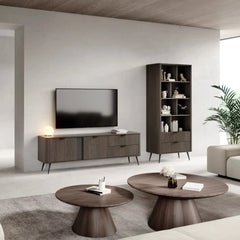 The sideboard cabinet positioned in a lounge area next to a tall shelving unit
